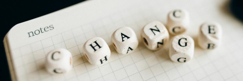A Close-Up Shot of Letter Dice on an Open Notebook