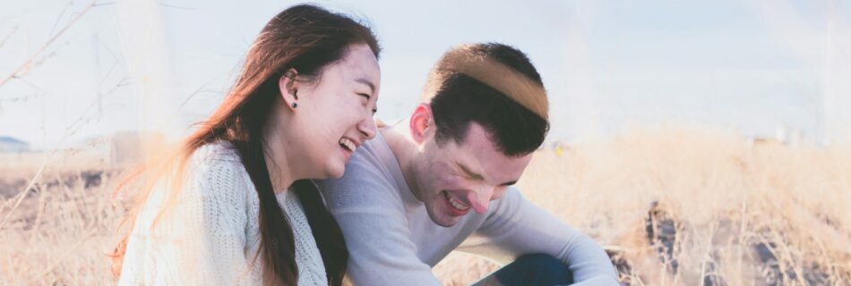 photo of man and woman laughing during daytime