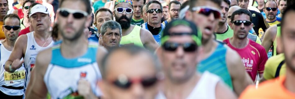 people in white tank top wearing sunglasses during daytime